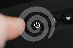 Power button being pressed on an electronic device
