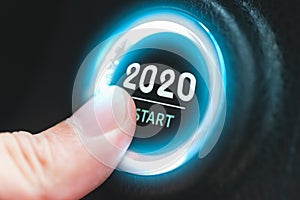 Finger pressing a 2020 start button. Concept of new year