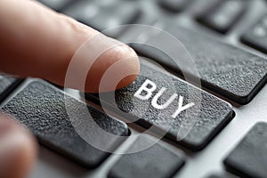 Finger pressing buy button on computer keyboard