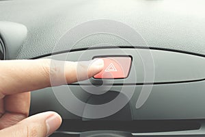 Finger pressing car emergency button
