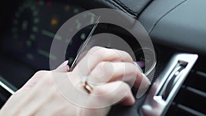 Finger pressing the Engine start stop button of a car. Stock. Car driver starting the engine