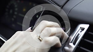 Finger pressing the Engine start stop button of a car. Stock. Car driver starting the engine