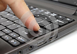 Finger pressing the Enter key on a keyboard