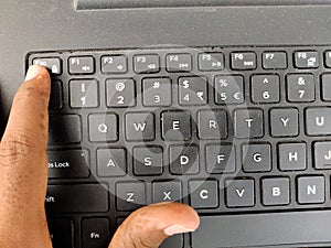 Finger pressing a Esc Escape button