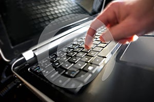 Finger pressing key on keyboard