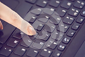 Finger. Pressing key. Notebook button