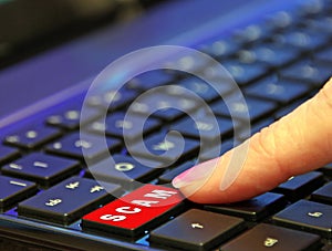 Finger pressing pushing down red hoax scam computer keyboard button word