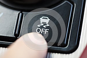 Finger pressing Traction Control System button