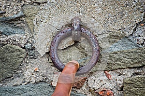 Finger pulls an old rusty iron ring