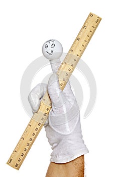 Finger puppet holding metric and inch ruler