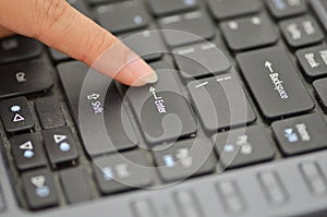Finger pushing the button of keyboard