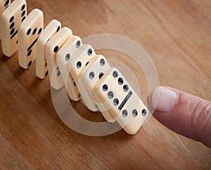 Finger pushing domino pieces