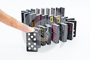Finger pushing dominoes.