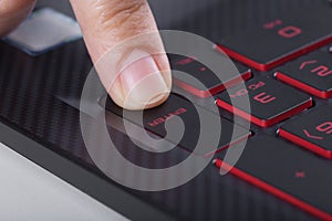 Finger pushing enter button on laptop keyboard