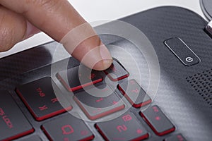 Finger pushing esc button on laptop keyboard