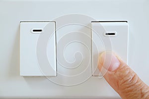 Finger pushing a switch for turn off light