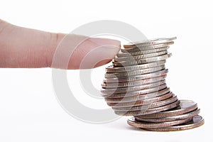 finger supporting the column of coins