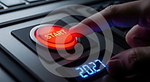 Finger about to press a red start button on a control panel