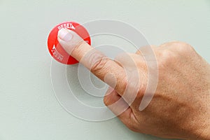 Finger touch on red emergency stop switch