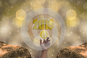 Finger Touch the start button to Starting 2019 Brightness Theme of Gold,happy new year with sparkling golden light bokeh and