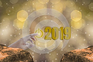 Finger Touch the start button to Starting 2019 Brightness Theme of Gold,happy new year with sparkling golden light bokeh and