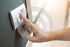 Finger is turning on or off on light switch
