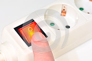 Finger turning off the power connector button