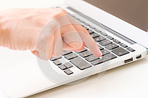 Finger typing enter on a laptop