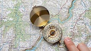 Finger is visible pointing at the compass. This scene suggests a