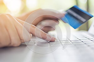 Finger of woman pressing keyboard to pay credit card to shopping