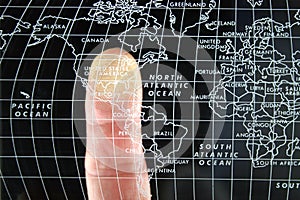 Finger on world Map