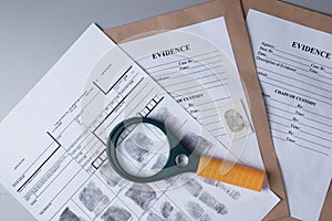 Fingerprint card, magnifying glass on  background of evidence packaging