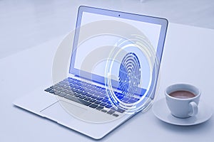 Fingerprint identification. Laptop and cup of coffee on table indoors