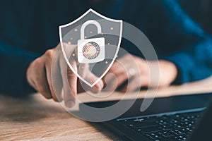 Fingerprint scan and shield icon, Man's finger scanning on virtual screen to log in to computer laptop, Security access with photo