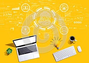 Fingerprint scanning theme with computers with a light bulb