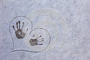 fingerprint on the snow. Three tracks from hands on the snow in painted heart. Love in the winter.