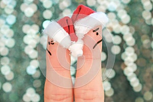 Fingers art of couple celebrates Christmas. Concept of man and woman during quarrel in New Year.