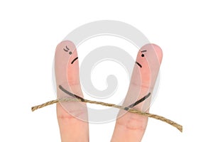 Fingers art of couple. They playing tug of war with rope isolated on white