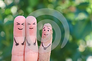 Fingers art of family. The couple laughs at the children in the mud