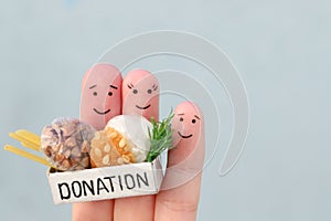 Fingers art of family. Man  and woman holding donation box with food
