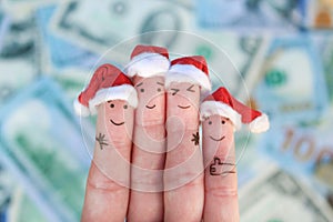 Fingers art of friends celebrates Christmas on the background of money. The concept of a group of people laughing in new year hats