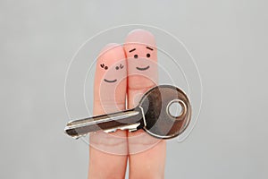 Fingers art of happy couple. Family holds house key