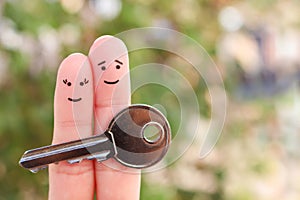 Fingers art of happy couple. Family holds house key