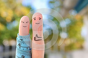 Fingers art of a Happy couple with tape measure. Concept of losing weight together