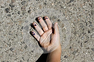 Fingers art of people. Concept of group of people with different personalities. Childish hand on background of asphalt with