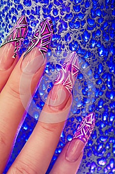 Fingers with beautiful manicure in pink style