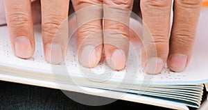 Fingers Of Blind Man Touching Page On Braille Book