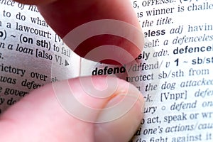 Fingers with defend text photo