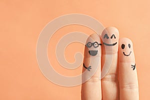 Fingers with drawings of happy faces