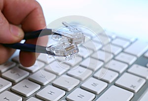 Fingers holding ethernet cables